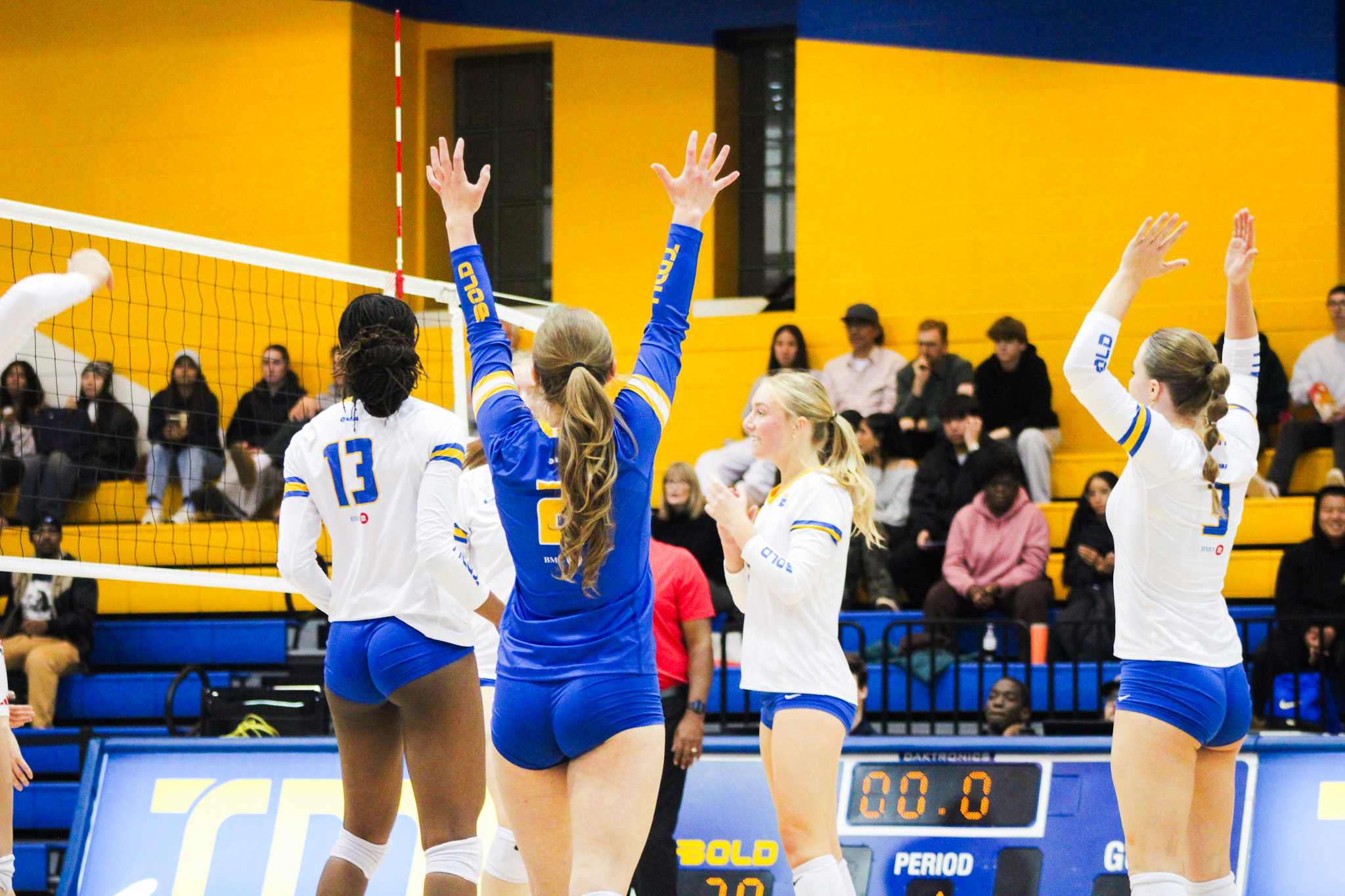 TMU celebrating point with their lebaro celebrating with her hands in the air