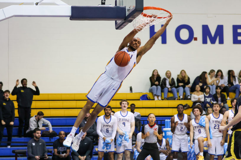 A TMU player dunks the ball