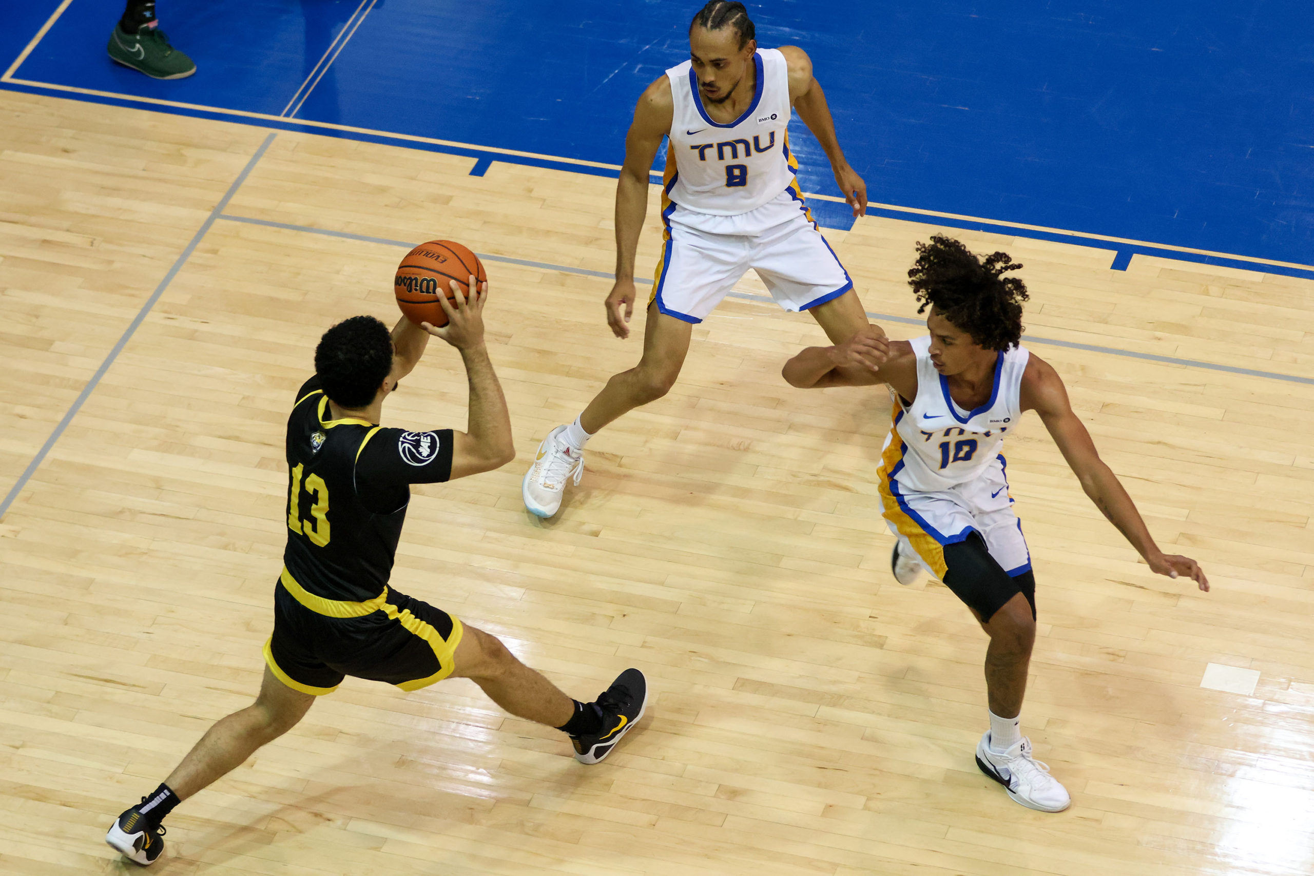 TMU defend a Dalhousie player from passing the ball