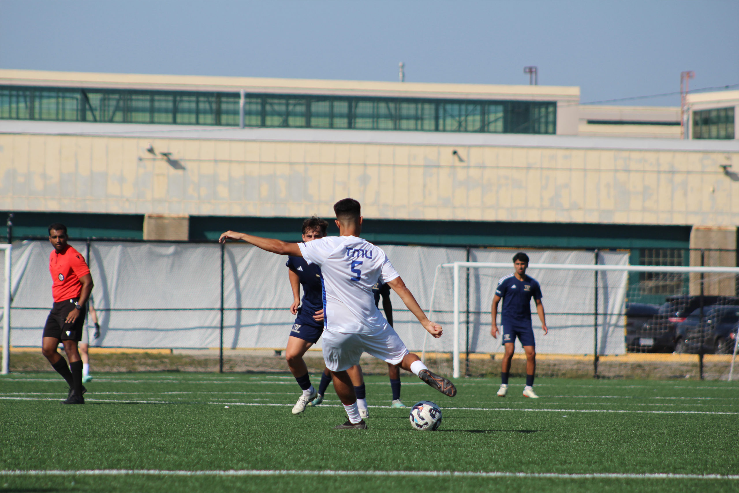 A TMU player takes possession of the ball