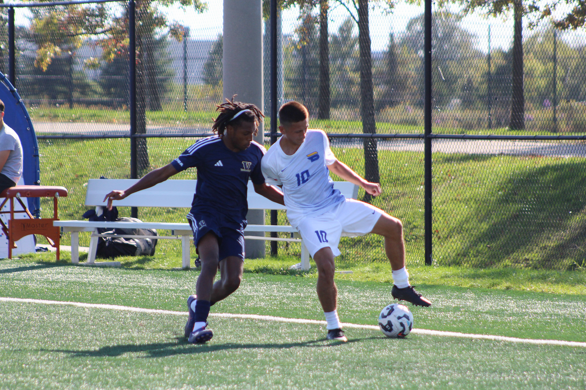 A TMU and Laurentian player fight for possession