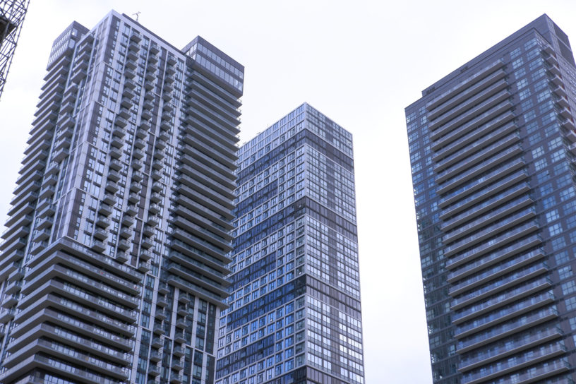 Image of three condos surrounded by sky.