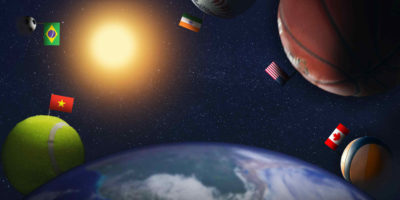 Illustration of the globe on the bottom of the frame with five sports balls floating around it. Each sports ball has a different countries flag on it.
