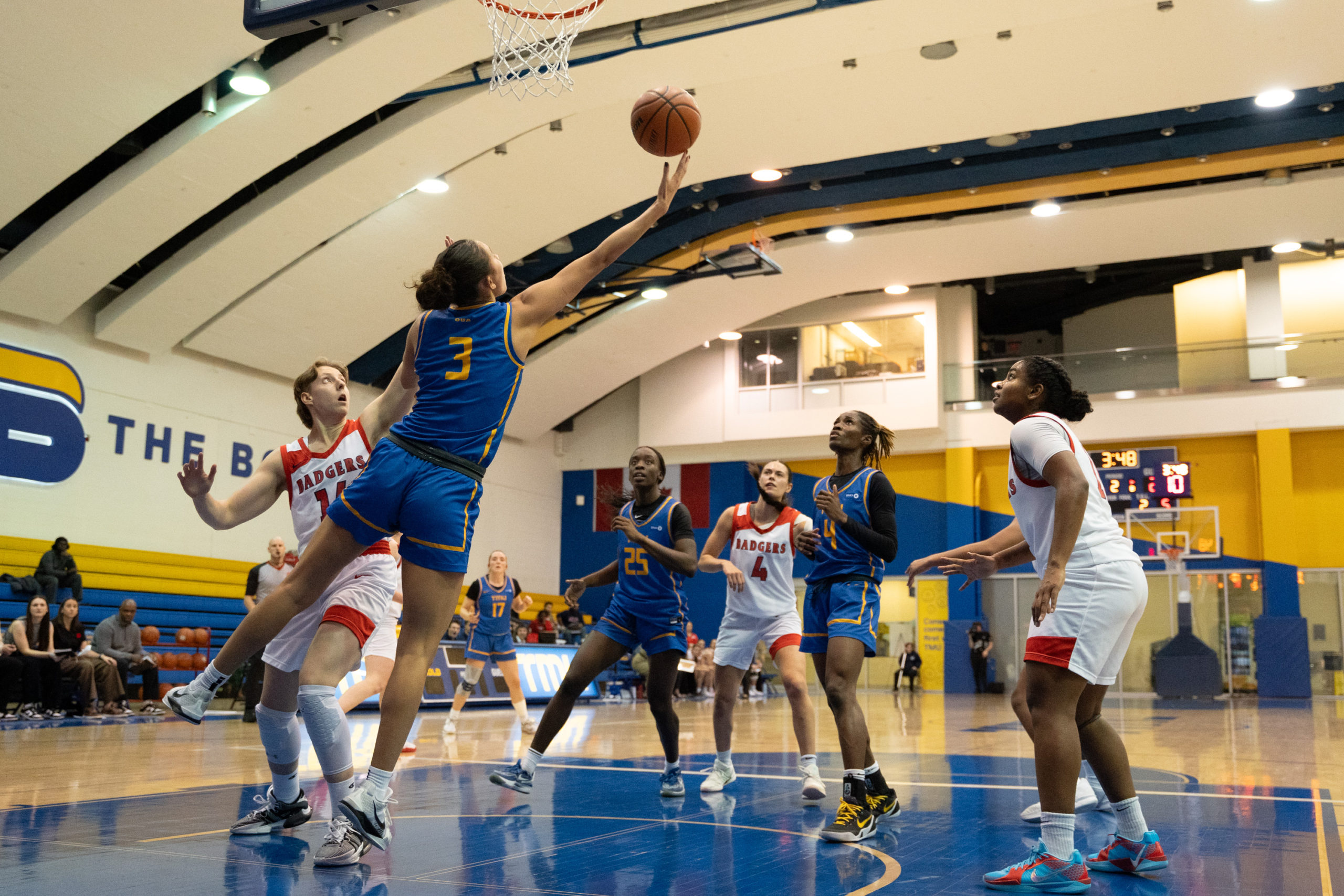 Hailey Franco DeRyck going for a reverse layup under the basket at the Mattamy Athletics Centre