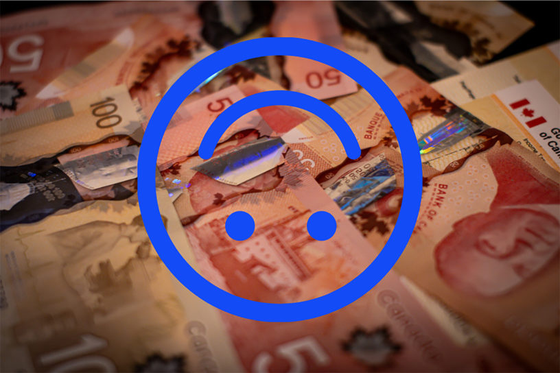 Image of fifty and one-hundred dollar bills laid out with an illustration of a blue upside-down smiley face on top.