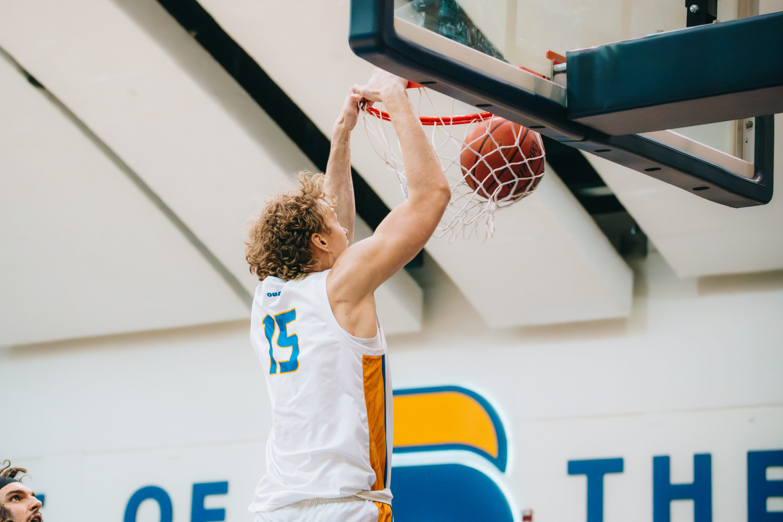 A TMU player dunks the ball