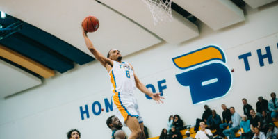 A TMU player makes a basket
