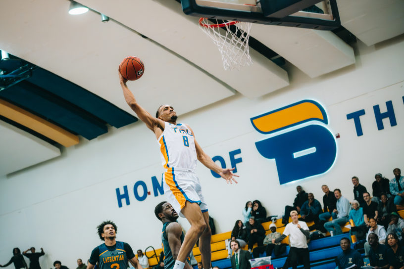 A TMU player makes a basket