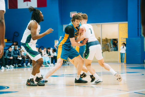 Aidan Wilson setting a screen on a Nipissing player at the Mattamy Athletics Centre