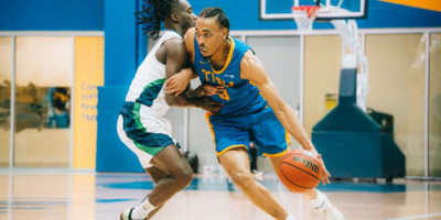 Deandre Goulbourne attacking a defender off the dribble at the Mattamy Athletics Centre