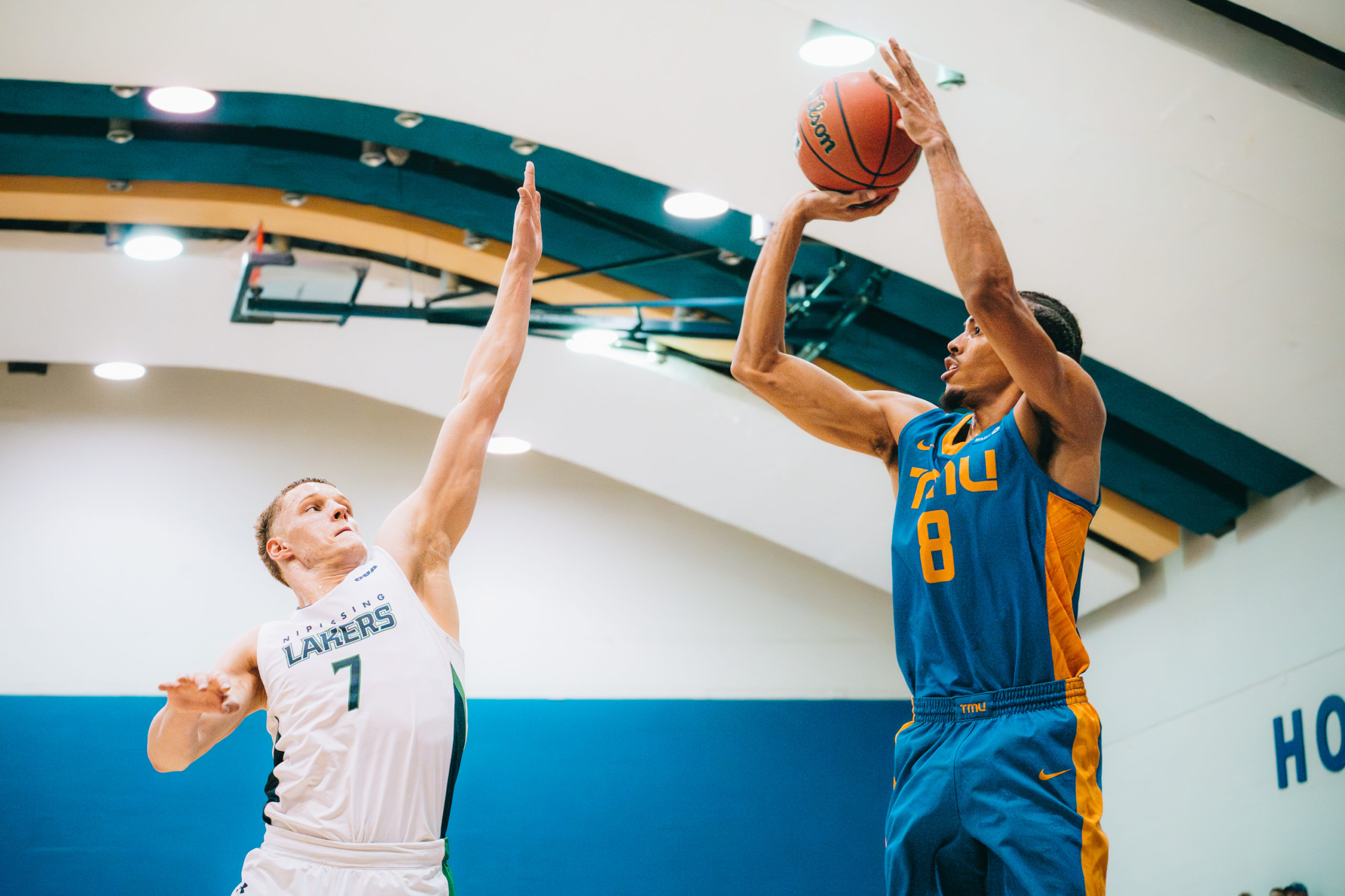 Deandre Goulbourne shooting a contested corner jump shot at the Mattamy Athletics Centre