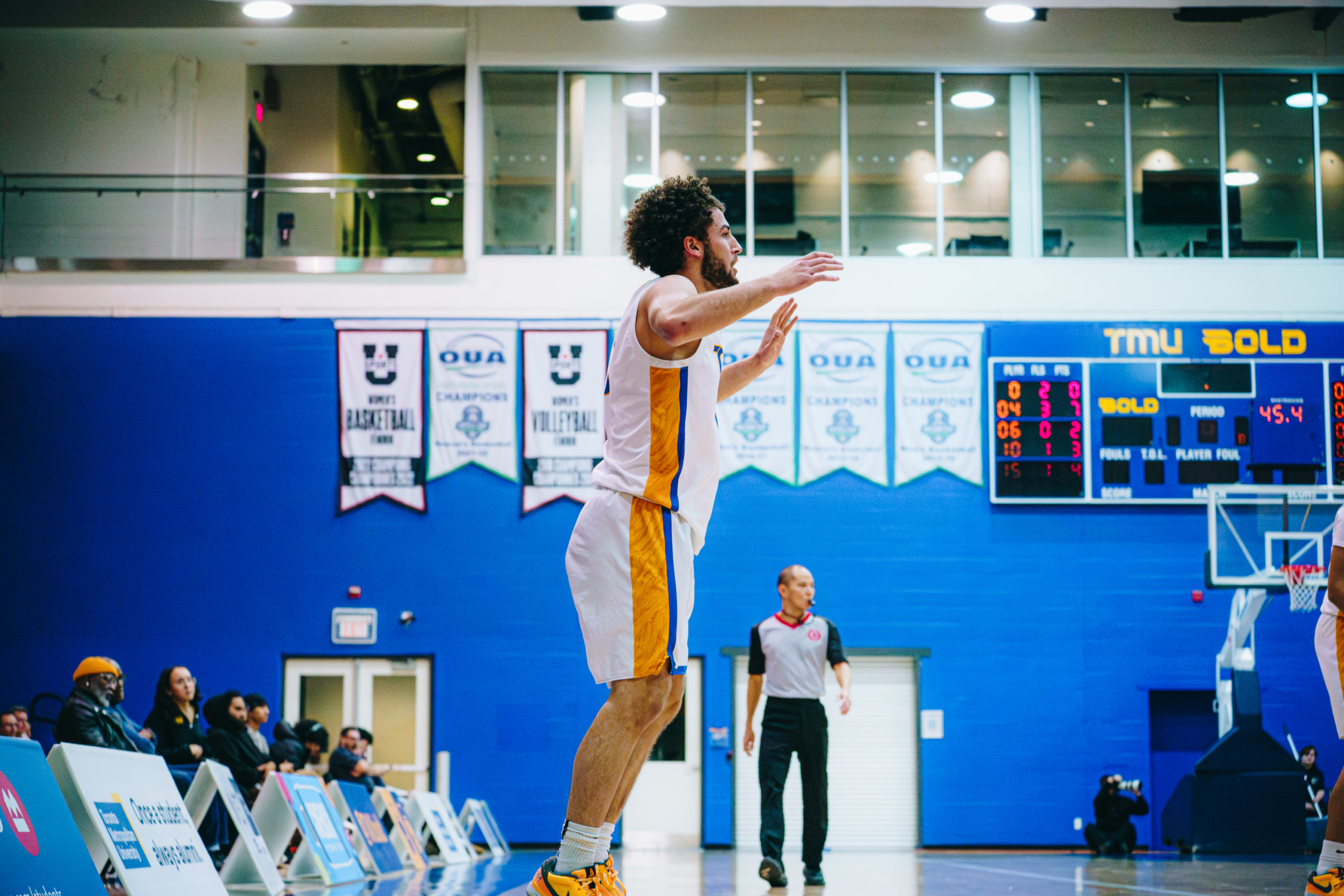 A TMU player calls out to a teammate across the court
