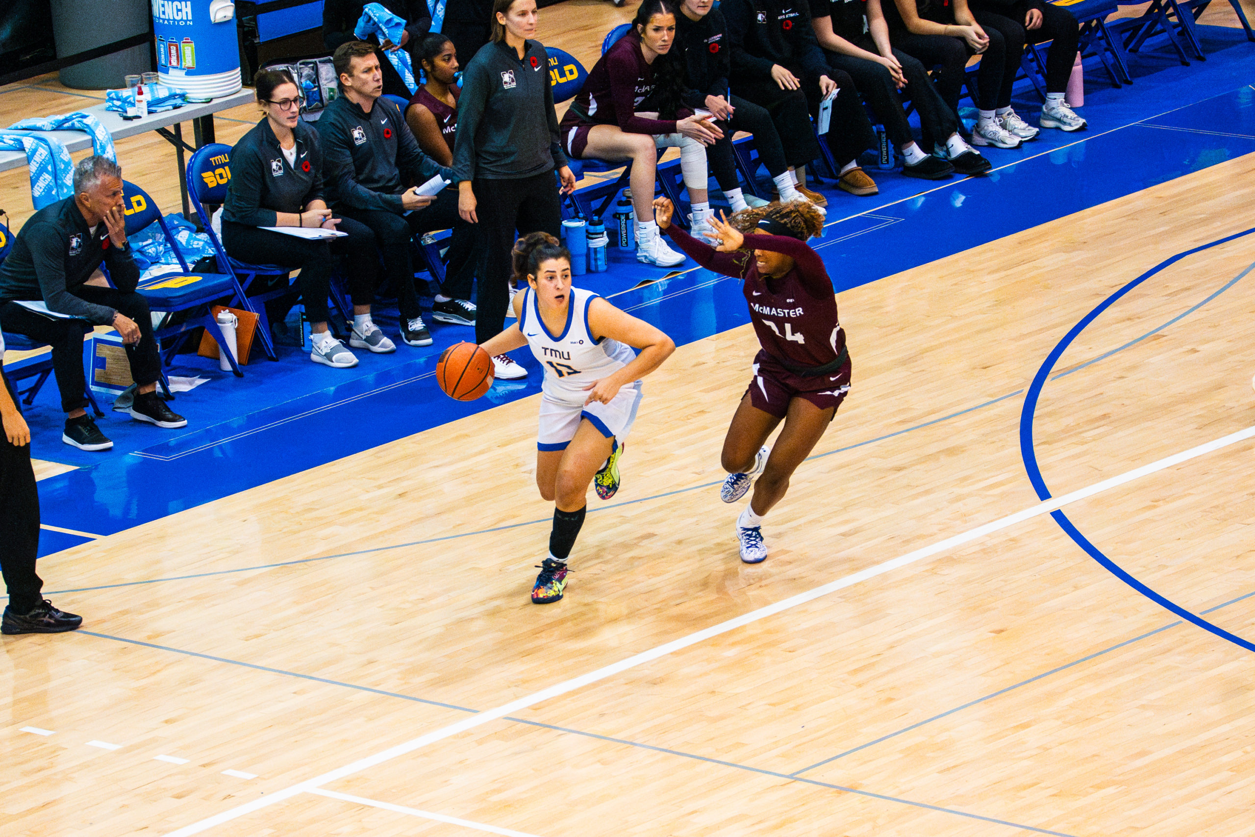 A women's basketball player attempts to gain possession