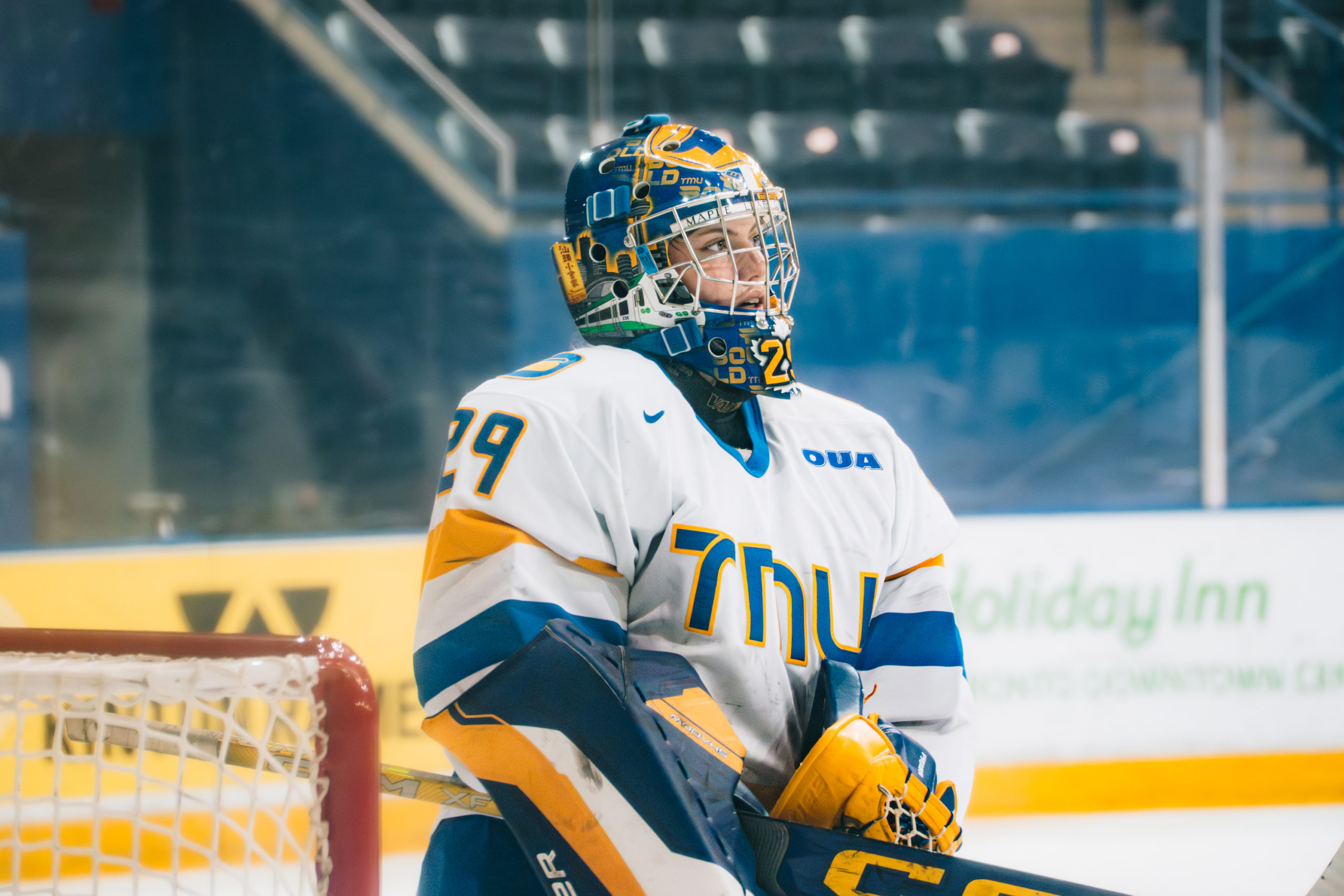 A TMU women's goalie in front of their net viewing a play at the Mattamy Athletics Centre