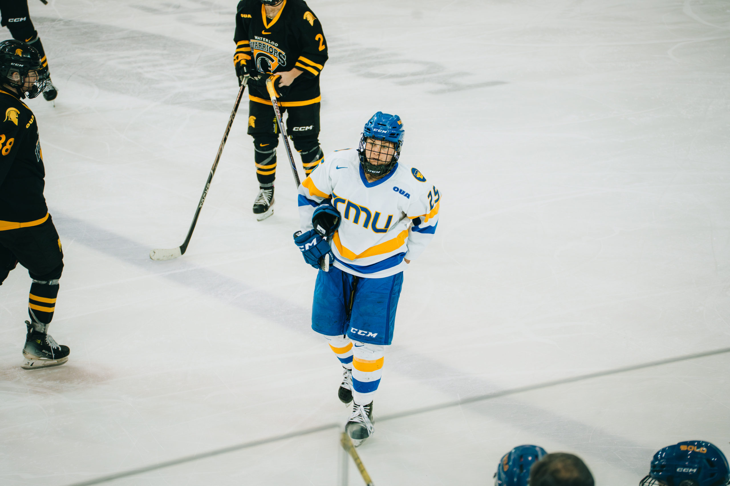 TMU women's hockey skating towards the TMU bench during a shift change at the Mattamy Athletics Centre