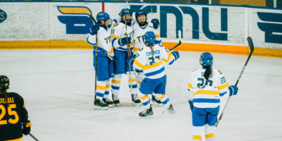 The TMU women's hockey team celebrating a goal at the Mattamy Athletics Centre
