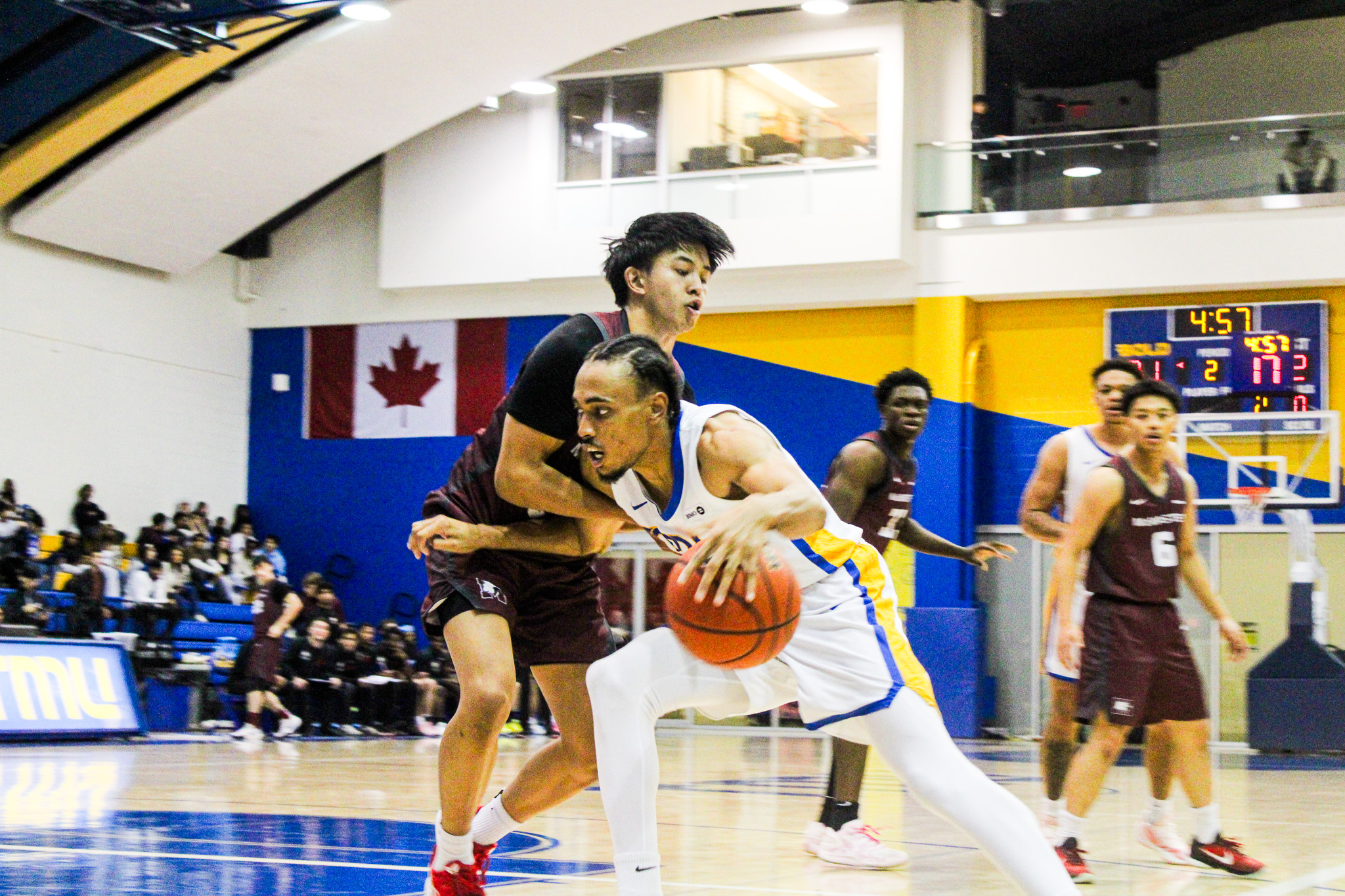 Deandre Goulbourne driving into a McMaster defender