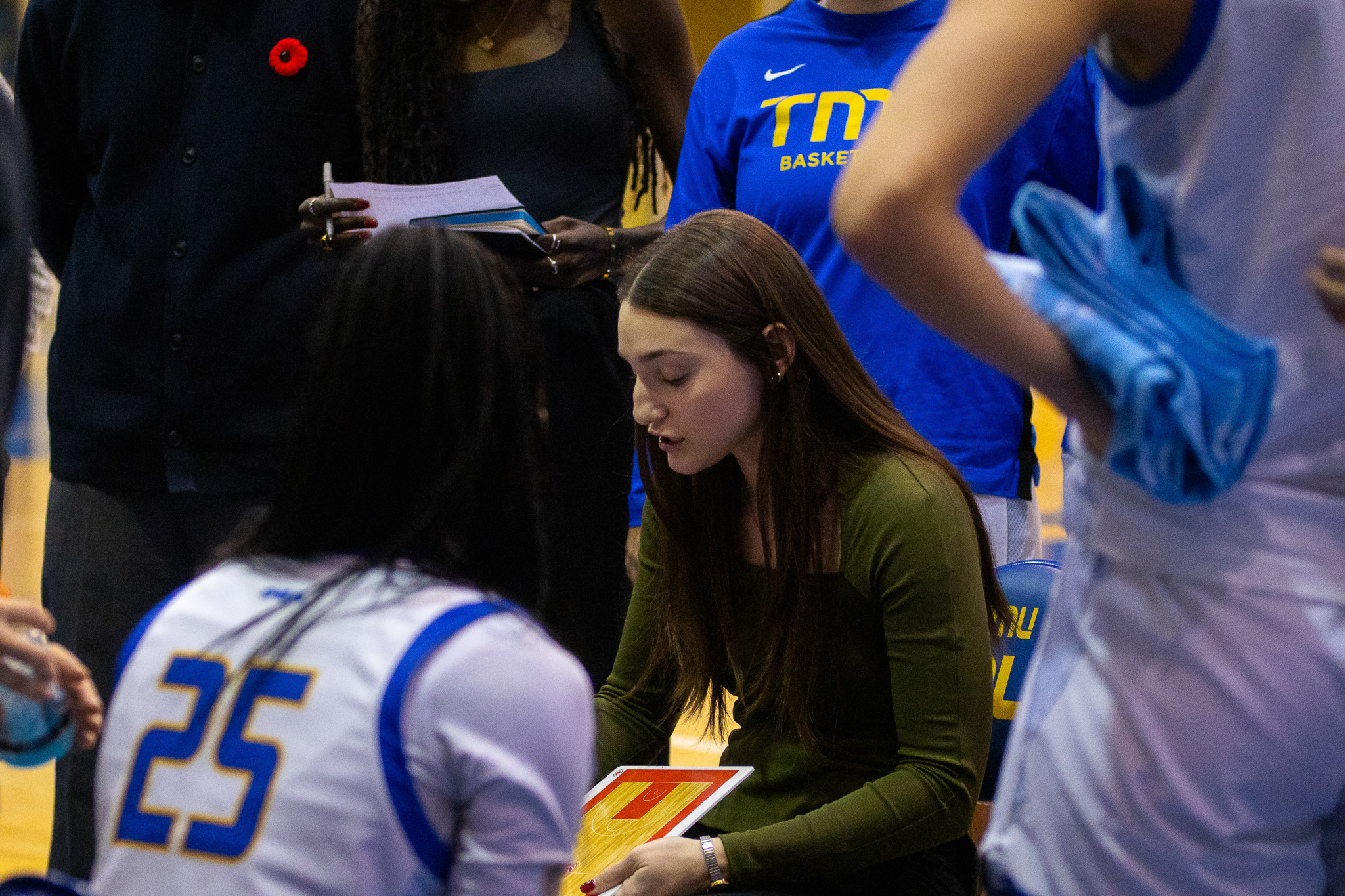 Coach Stefanija Mrvaljevic drawing up a play for her team during a stoppage of play at the Mattamy Athletics Centre