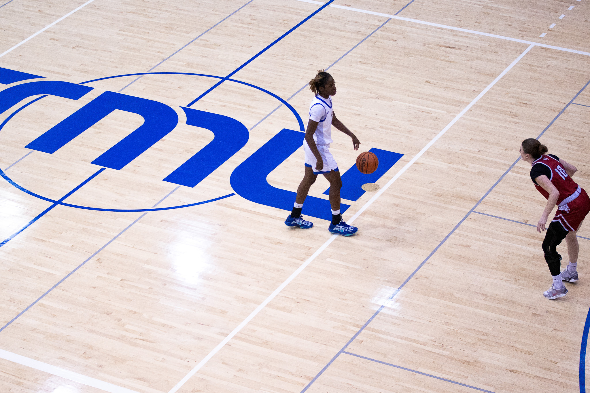 Myriam Kone dribbling the ball up the court past half at the Mattamy Athletics Centre