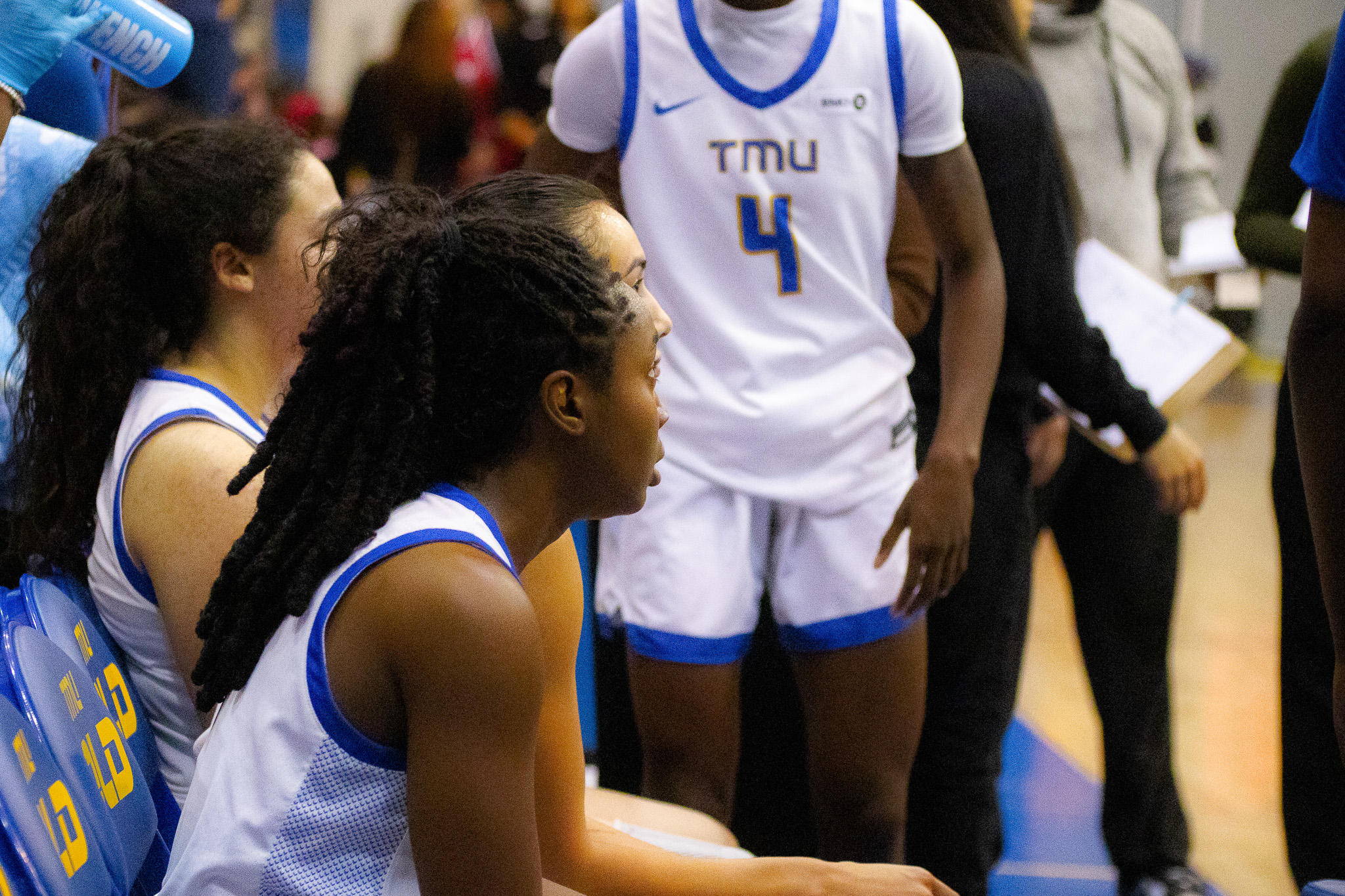 TMU women's basketball team gathered on the bench during a stoppage of play at the Mattamy Athletics Centre