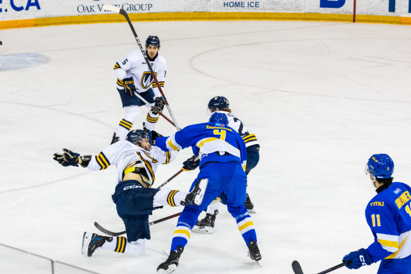 A scrum ensues on the ice