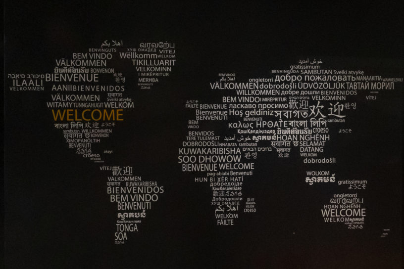 Image of a map of the world with text reading "welcome" in various languages.