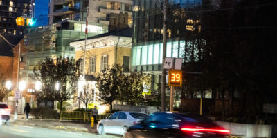 Image of cars driving down the street with a speedometer that reads "39 km/h".