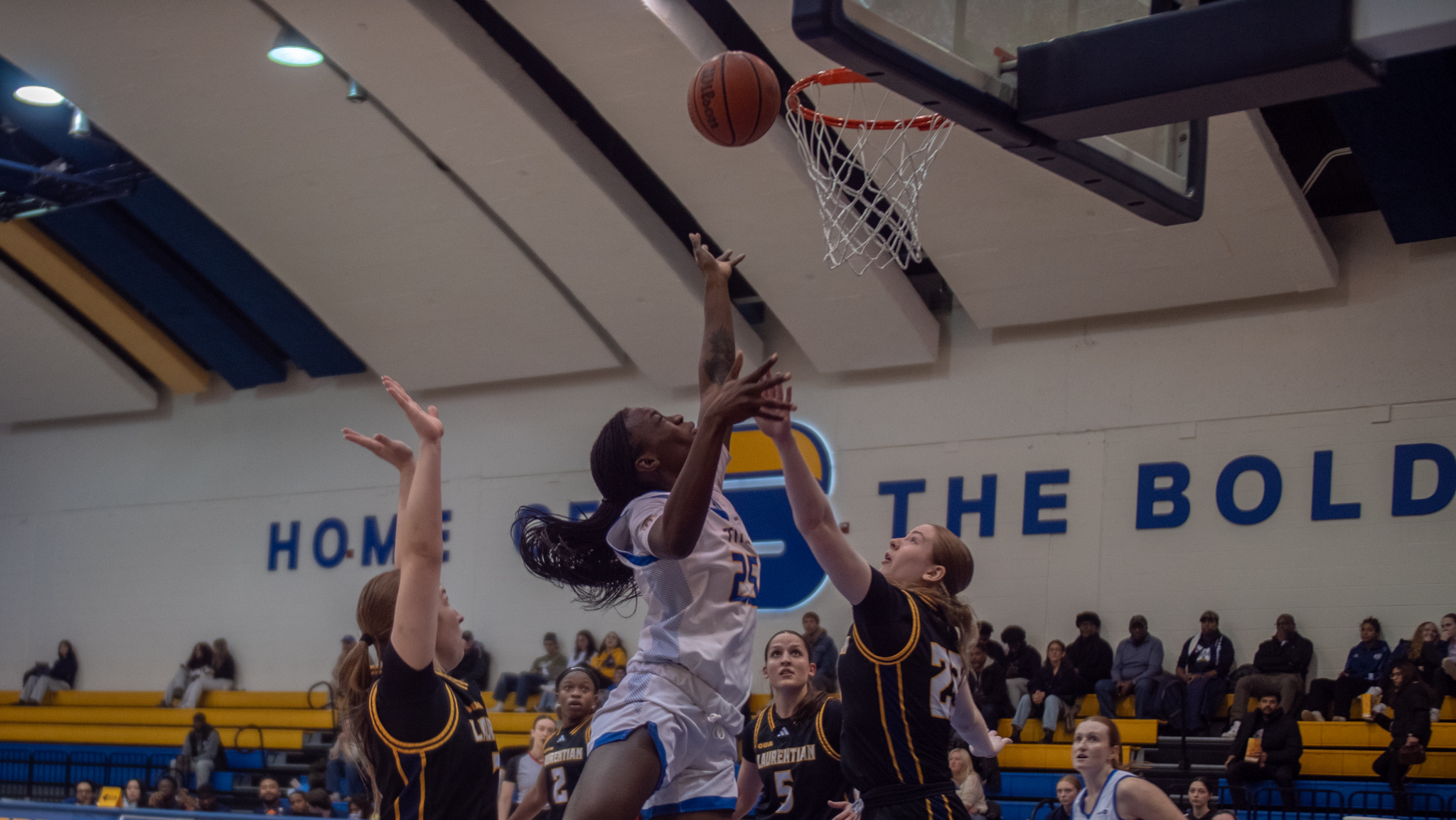 TMU and Laurentian fight for possession at the net