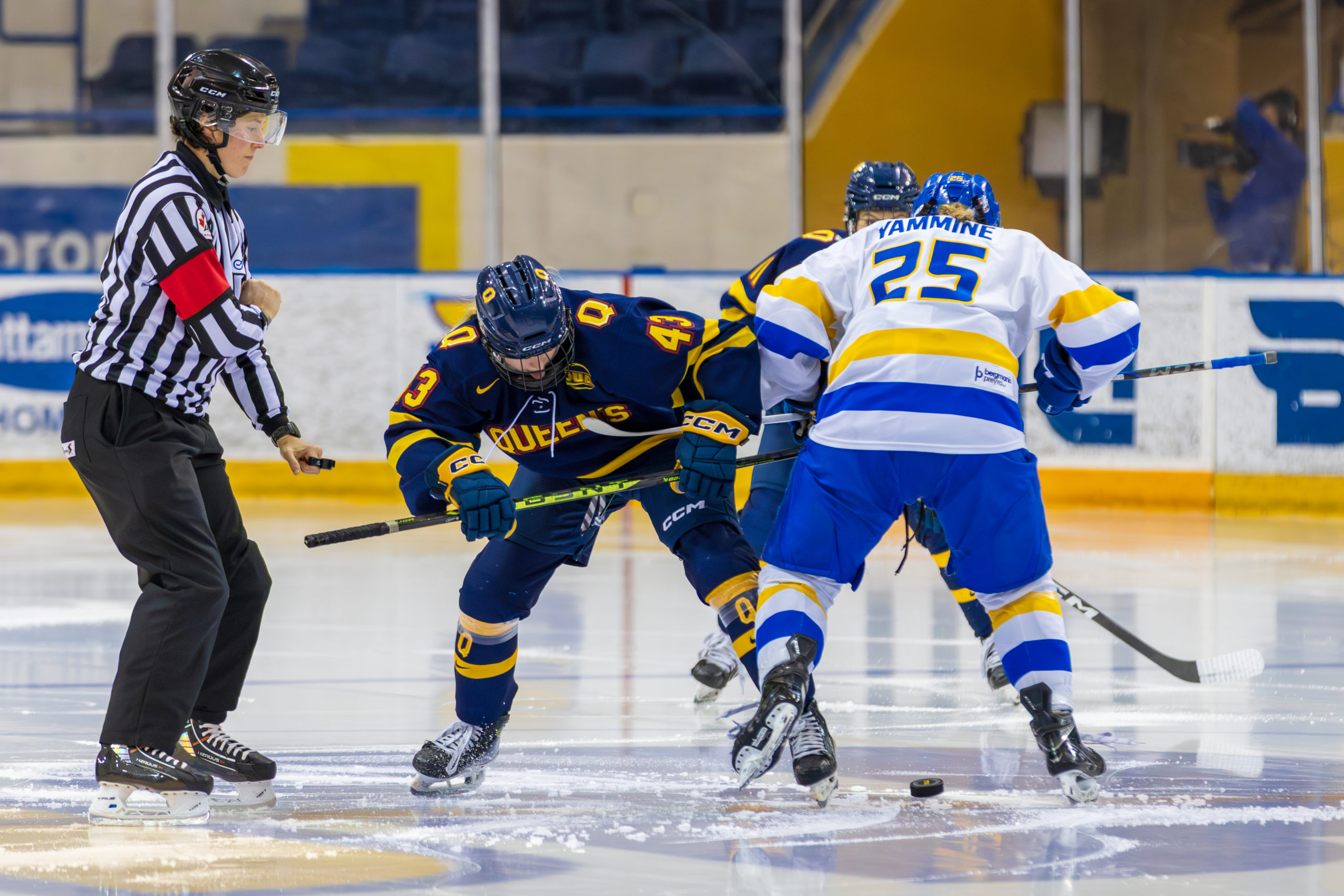 TMU and Queen's struggle for possession at the initial face-off