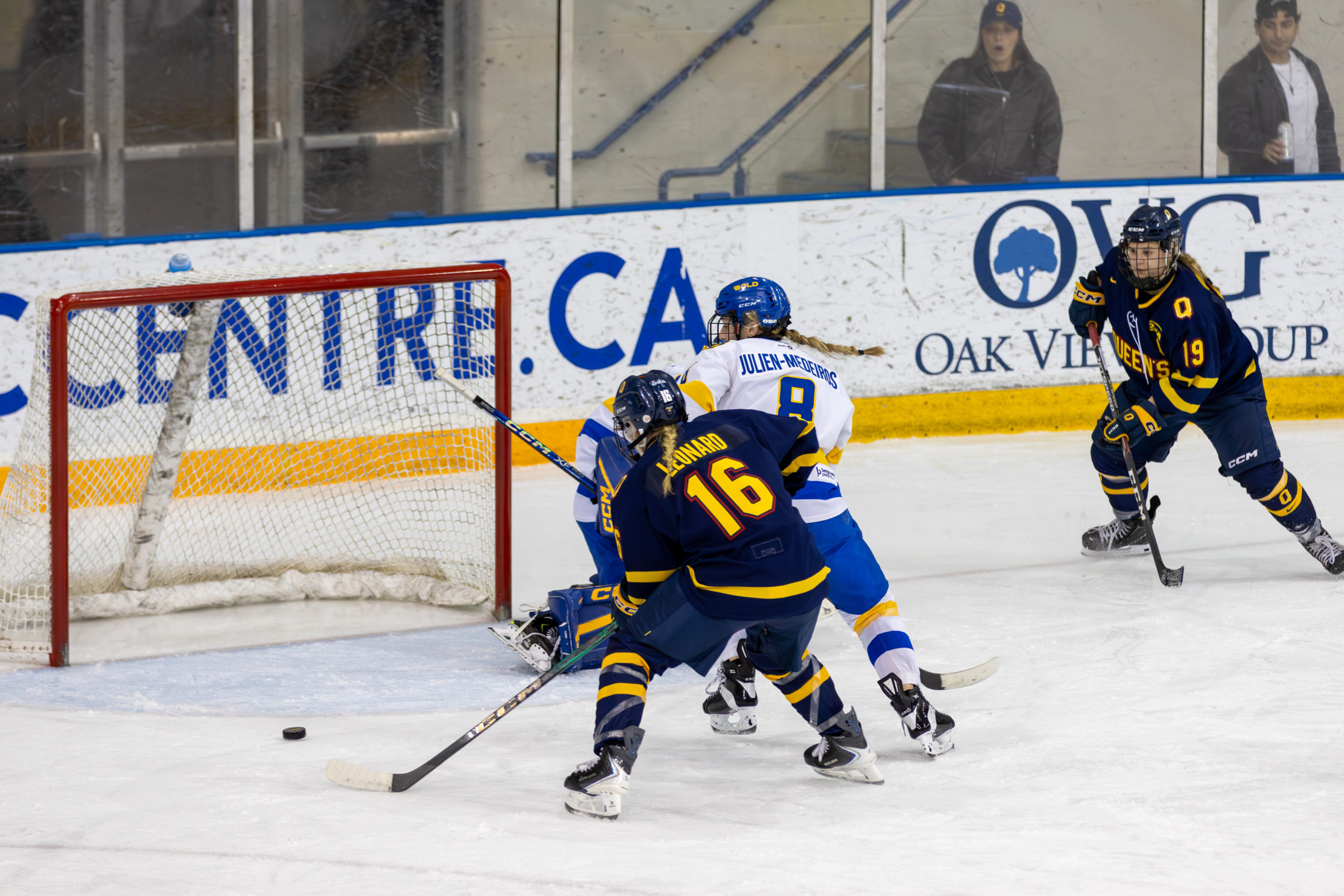 Queen's tries to feed the puck into TMU's net