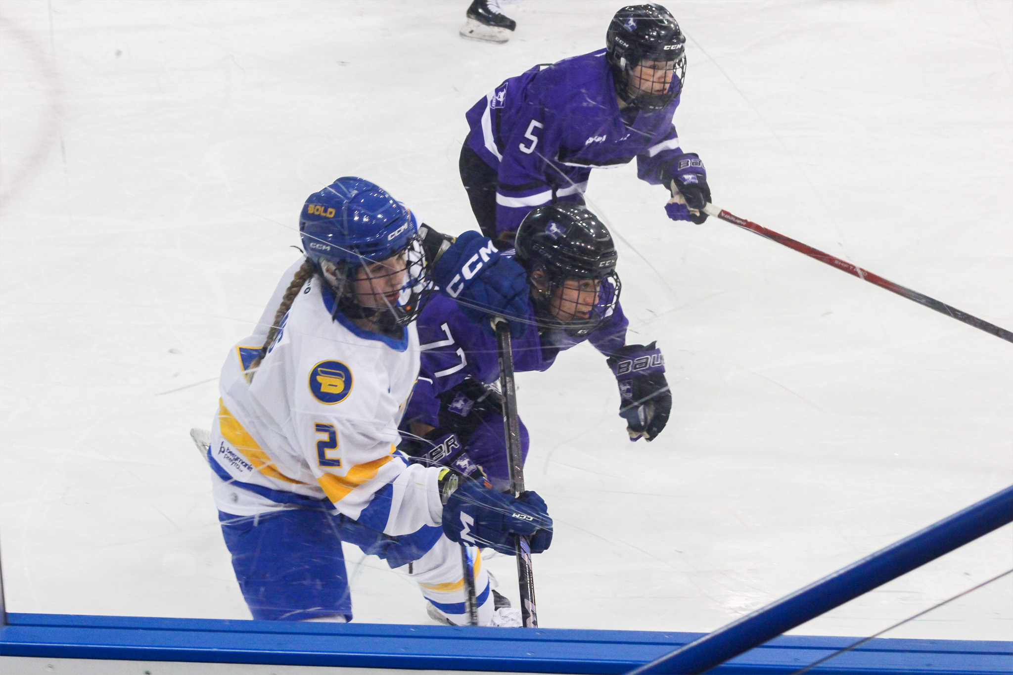 TMU and Western players push each other around for space on the ice