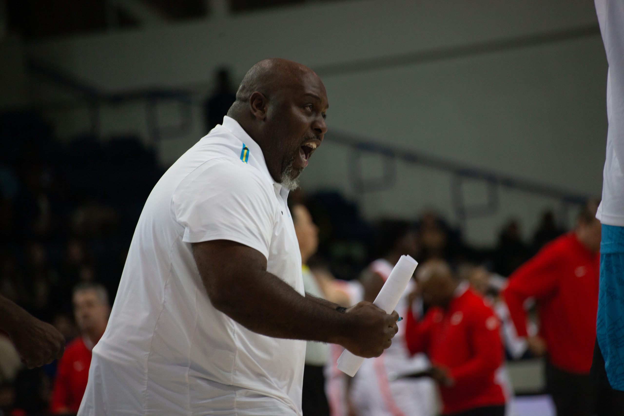 A team Bahamas coach celebrating a run by his team at the Mattamy Athletic Centre