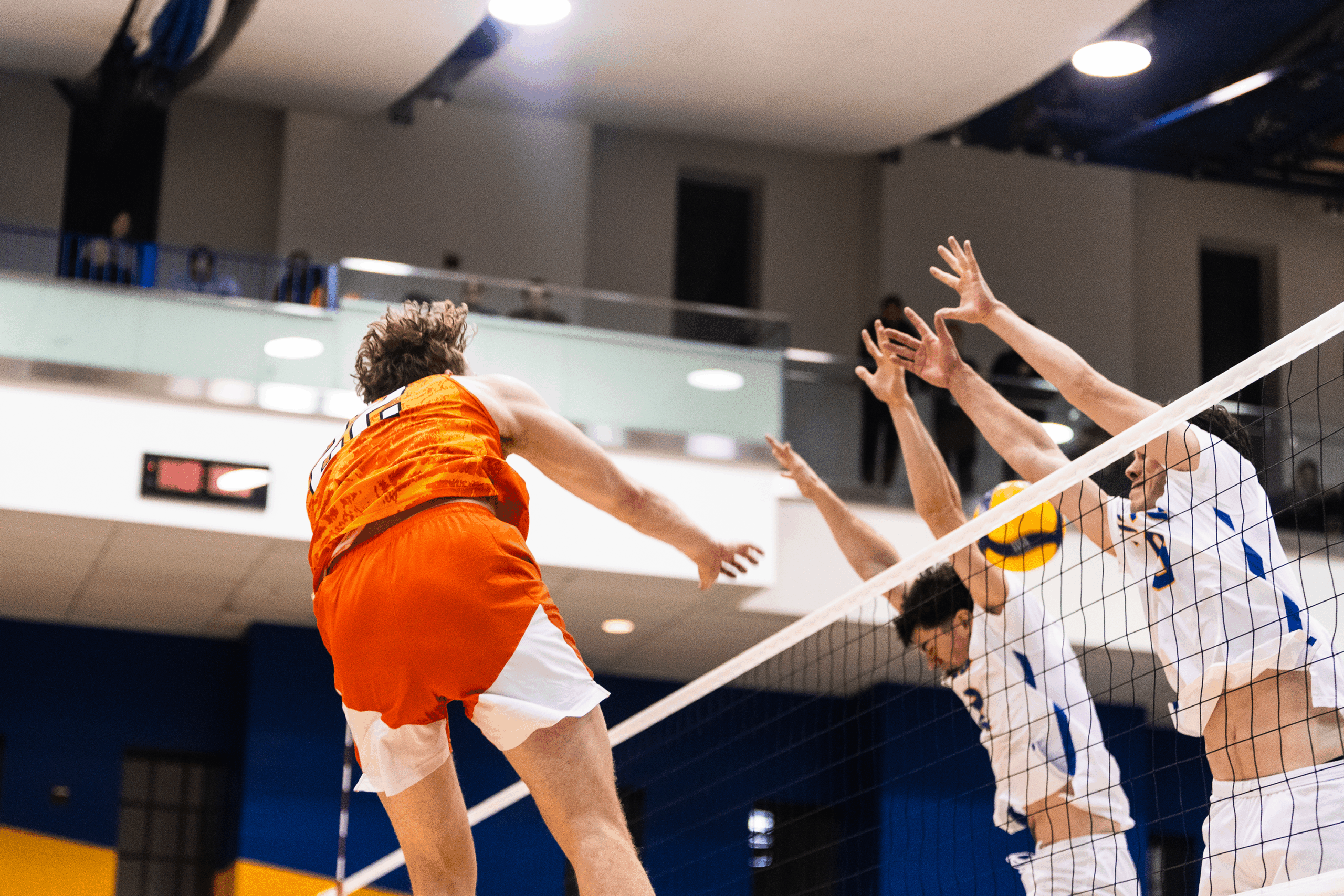 A Princeton player sends the ball past TMU blockers