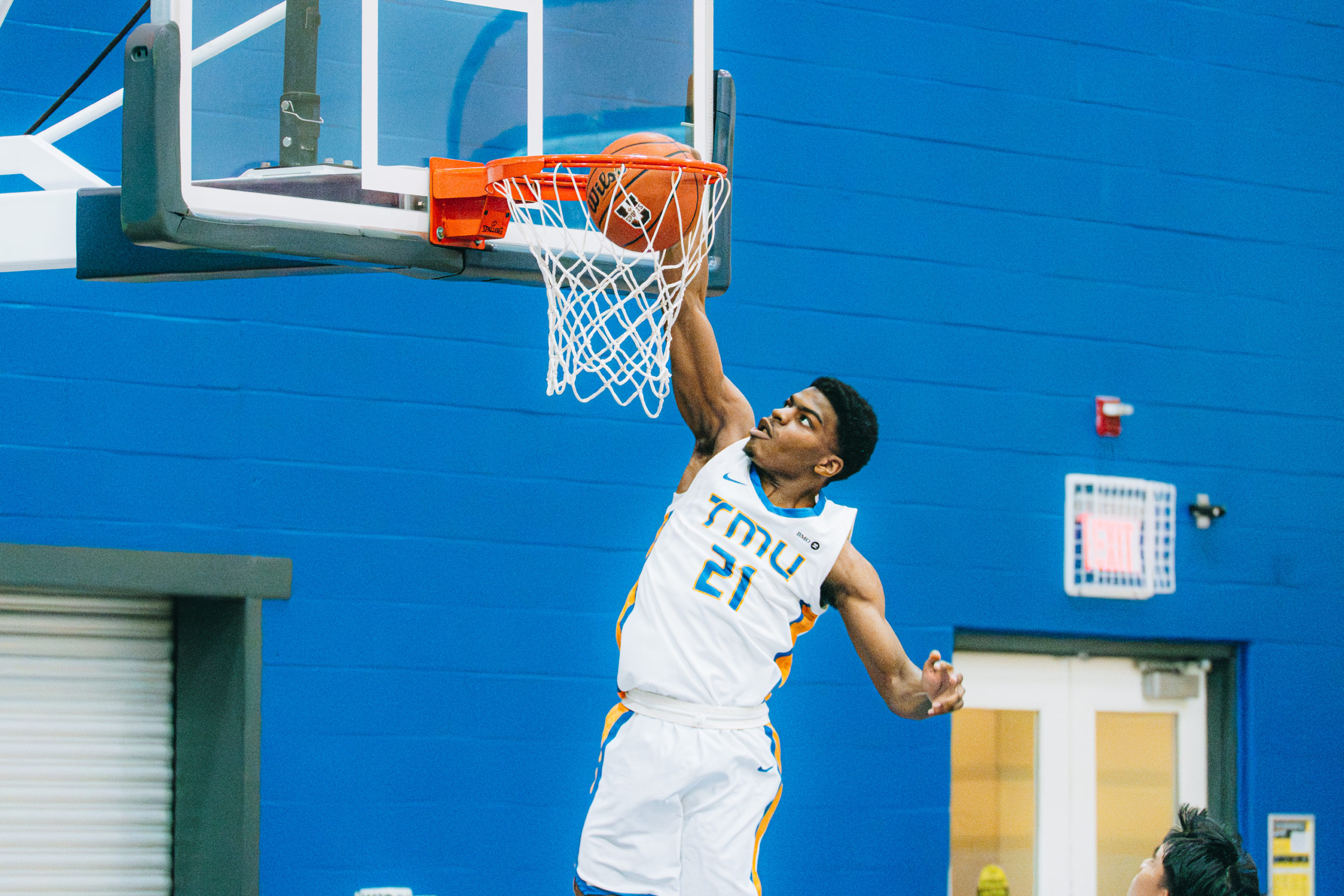 TMU player right hand dunk in transition 