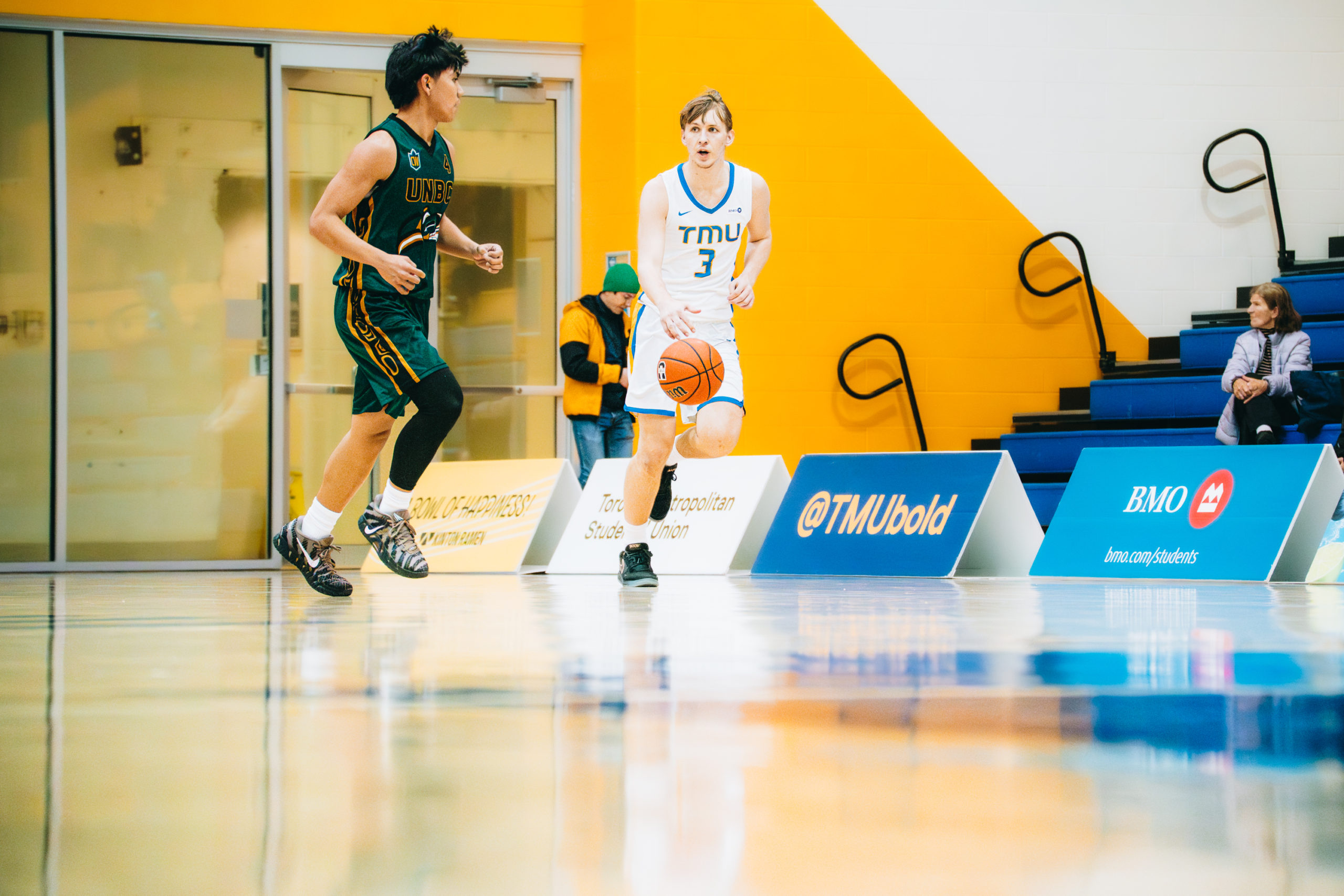 TMU playter bring the ball upo the court