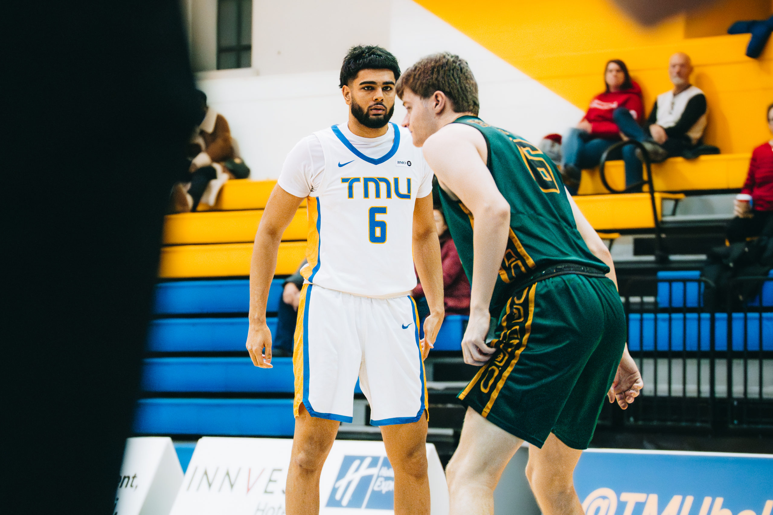 TMU player being defended by a UNBC player