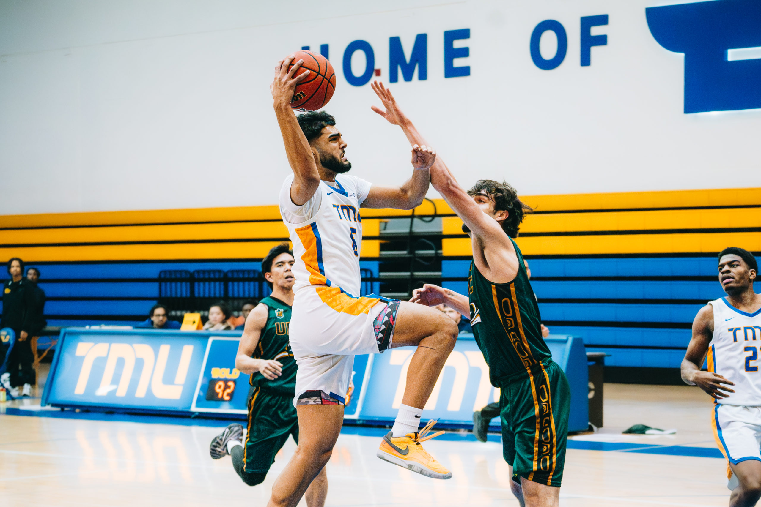 TMU player goes for a right handed contested layup 