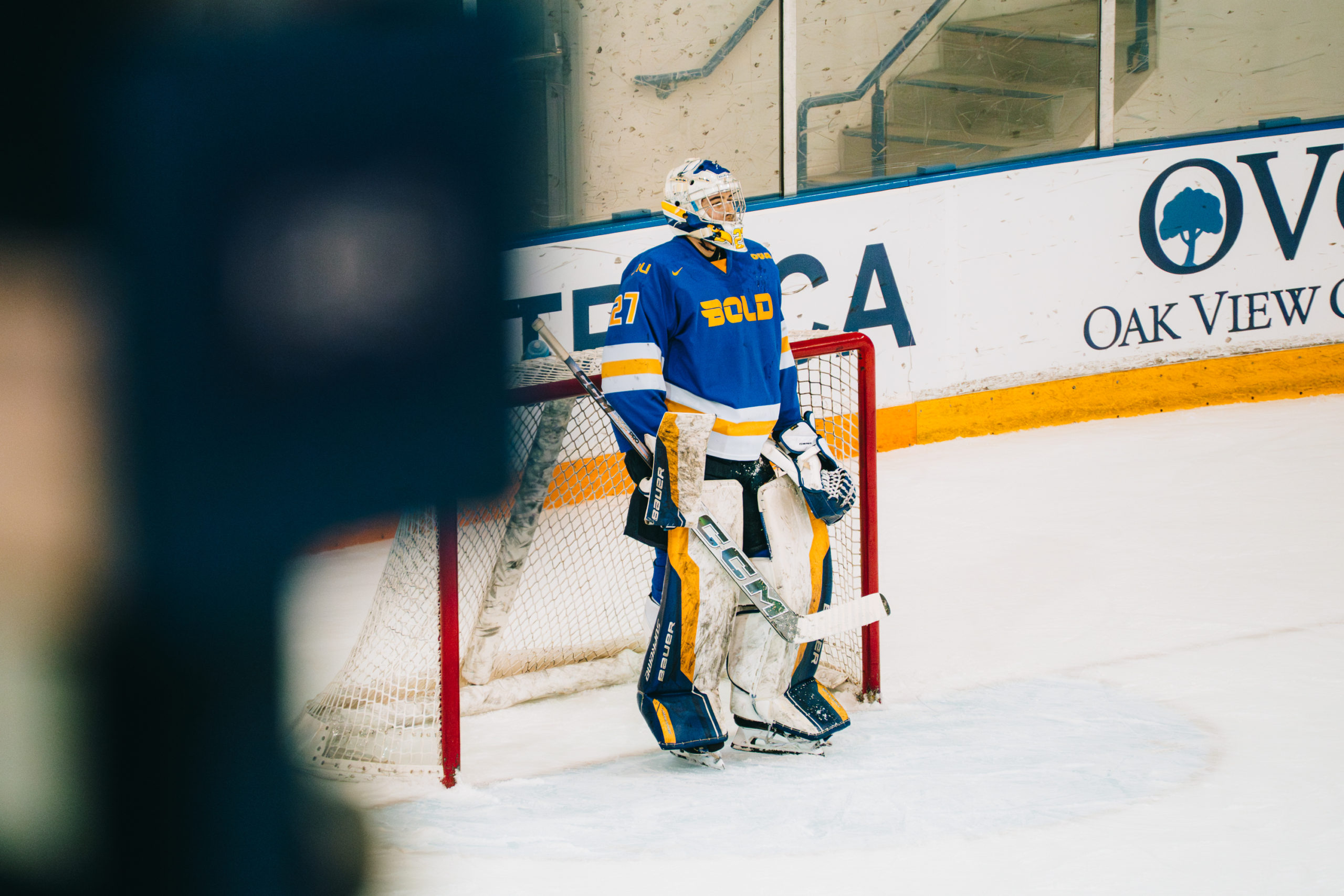 A TMU Bold mens hockey player stand in front of the net at the Mattamy Athletic Centre