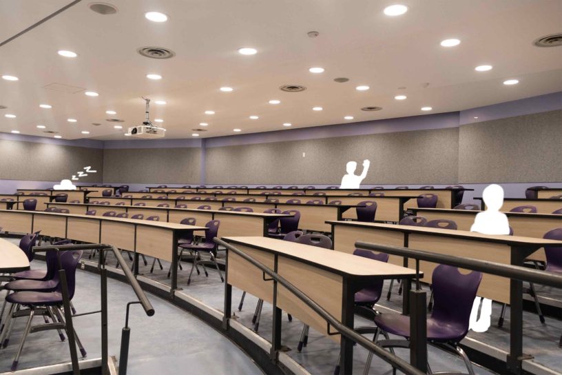 Photo of a empty lecture hall, with three white sketched figurines occupying three seats.