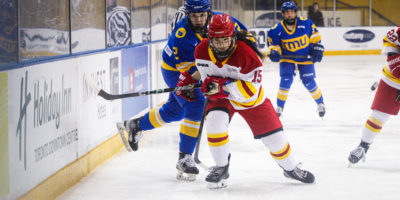 TMU and Guelph both rush to the puck along the boards