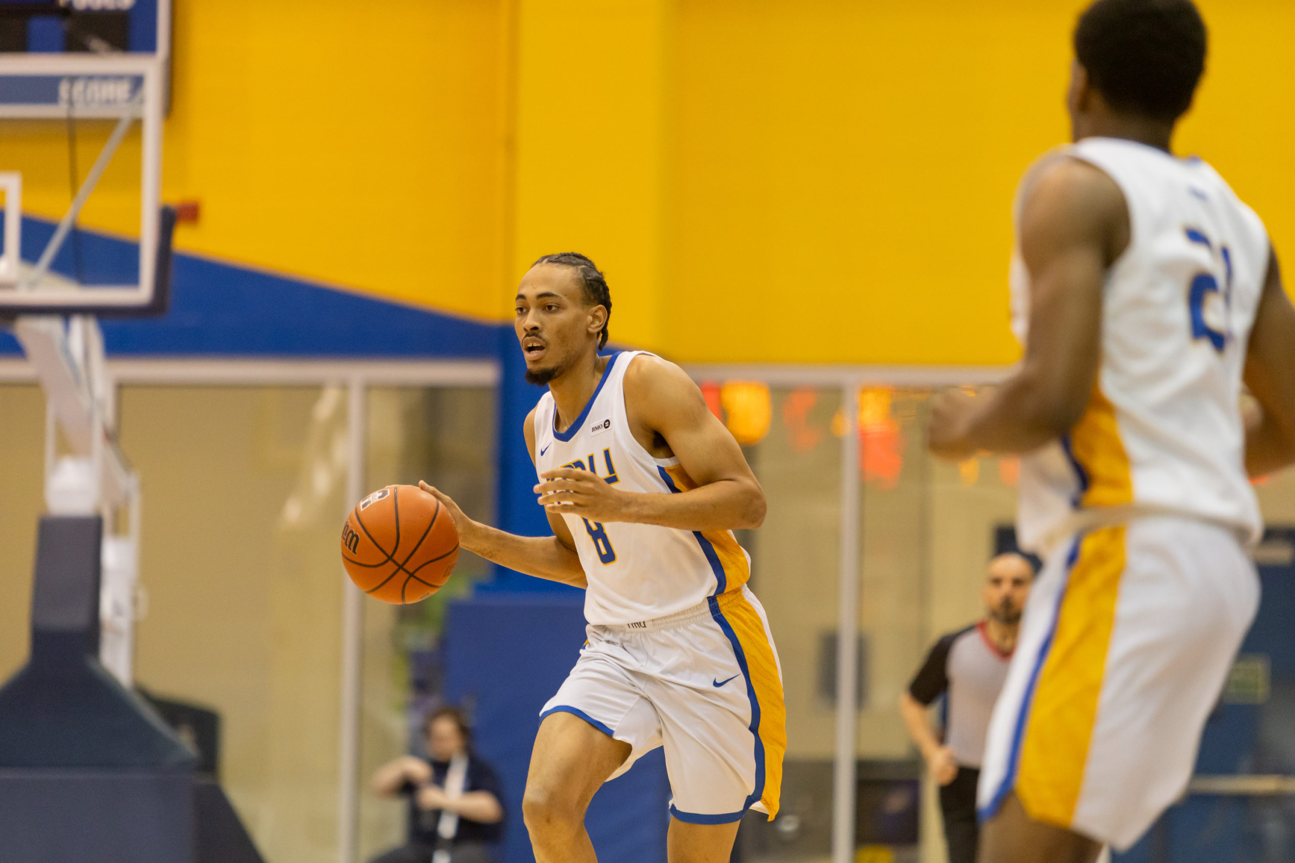 DEANDRE GOULBOURNE DRIBBLES UP THE BALL