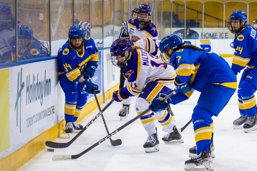 TMU players battling for the puck