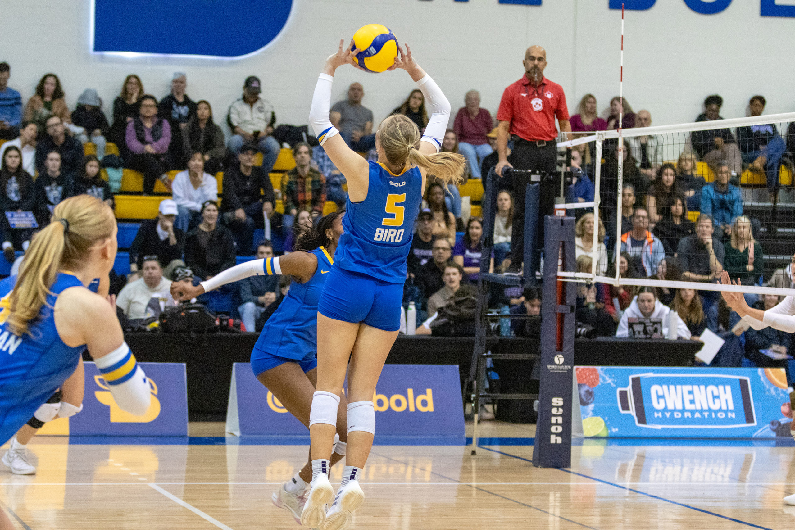 A TMU player sets the ball to her team