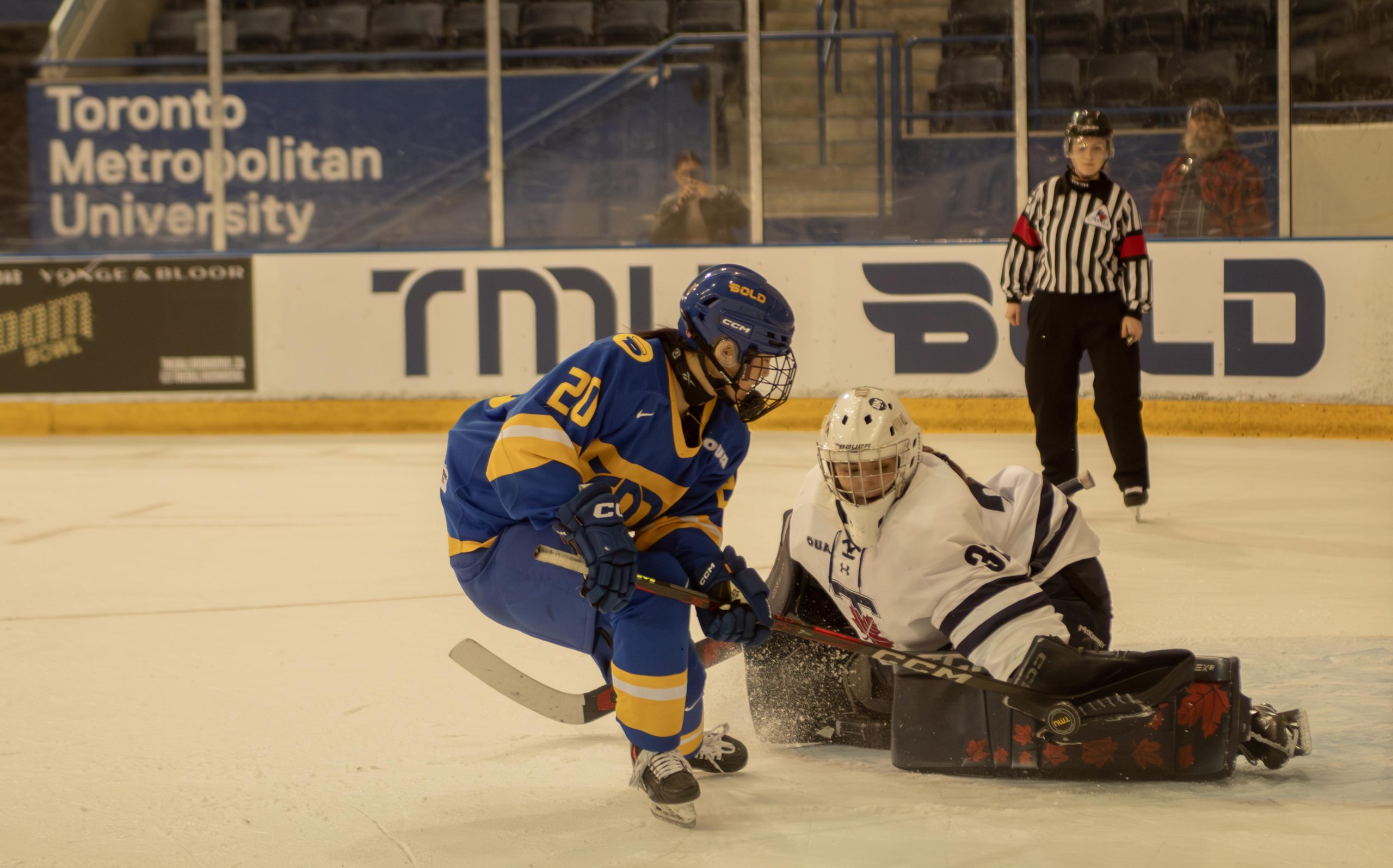 U of T's goaltender protects her net as TMU makes a shot attempt