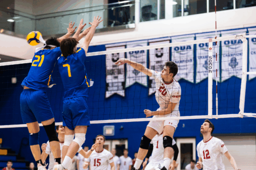 TMU's front line attempts to block a hit