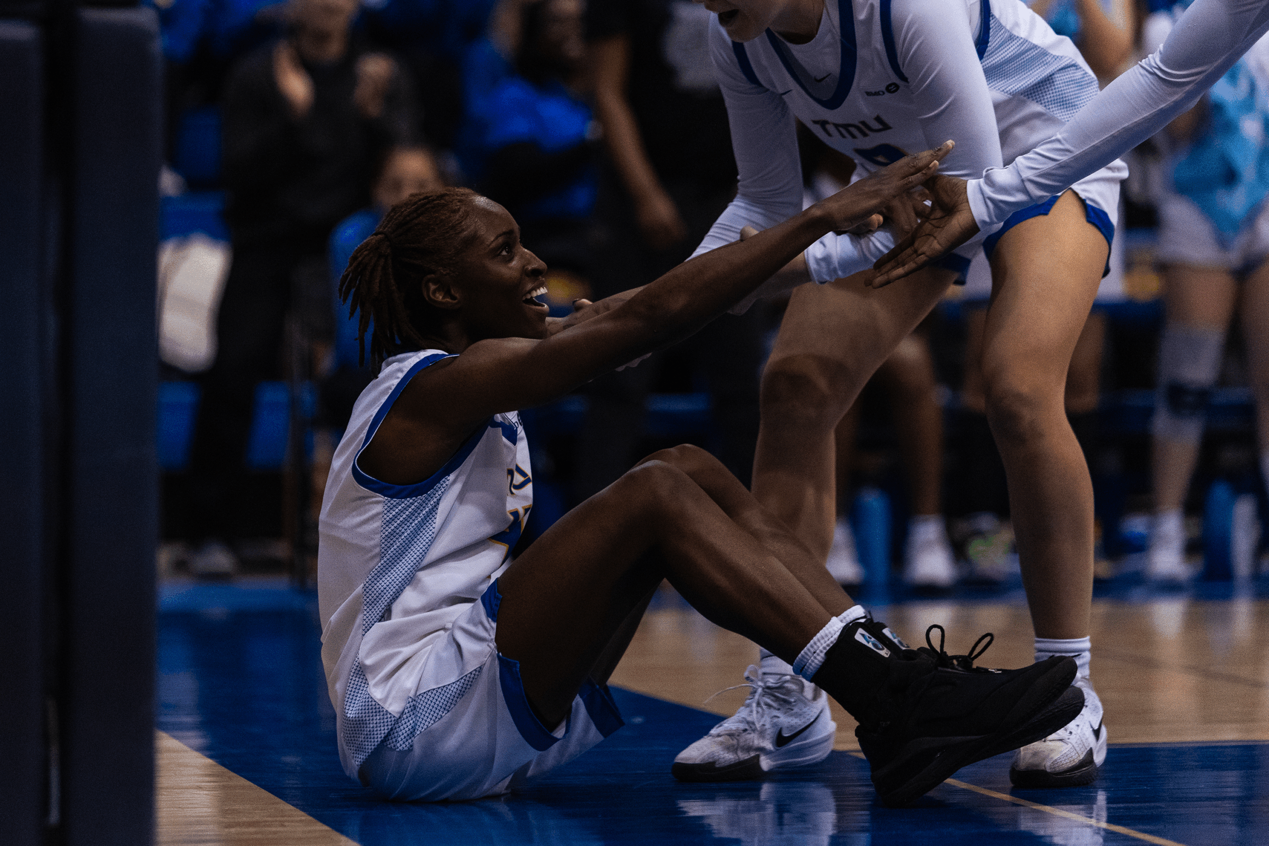 Myriam Kone's teammates help her up off the ground