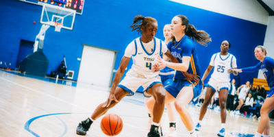 A TMU player maintains possession as a Lakehead player tries to steal