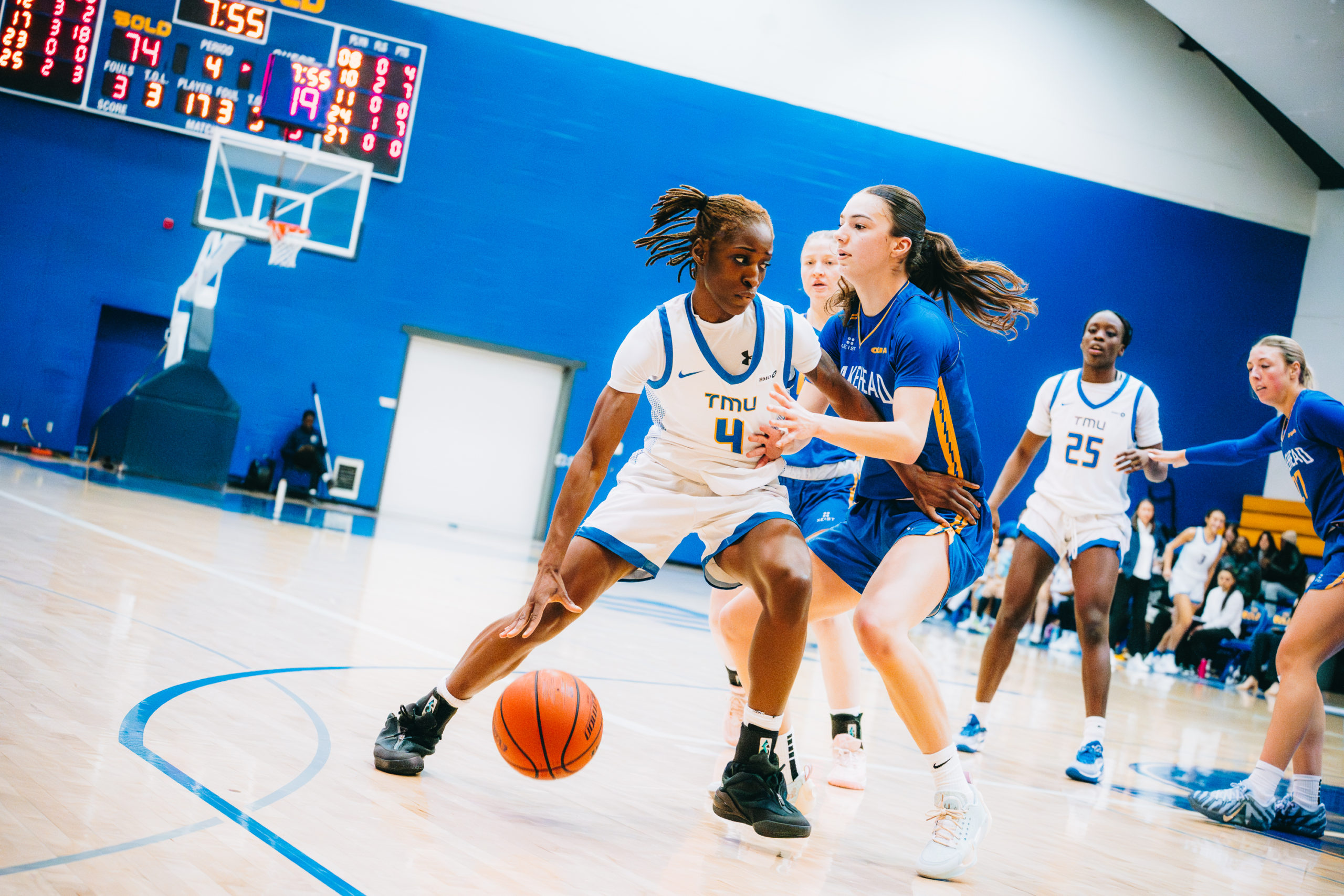 A TMU player maintains possession as a Lakehead player tries to steal
