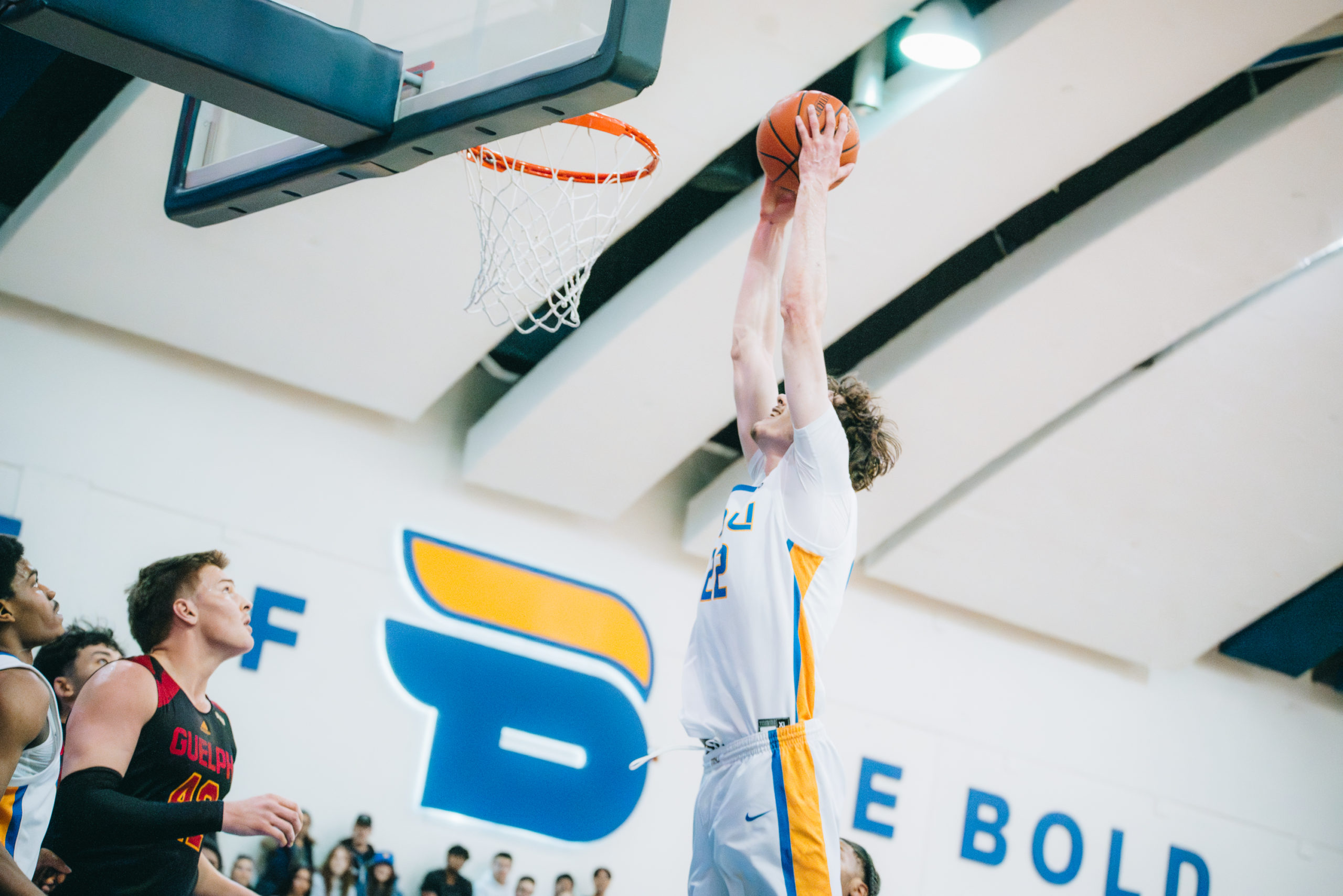 A TMU player makes a basket