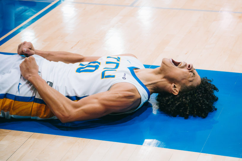 A TMU player celebrates a point while lying on the ground